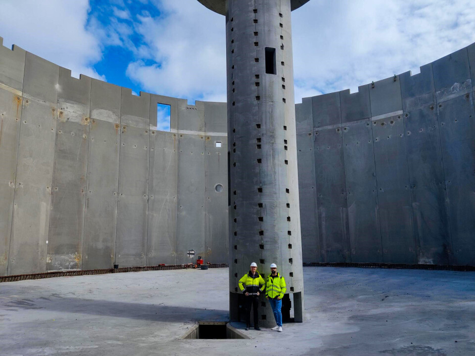 AKVA group project manager Mads Skøtt and engineer Mehrdad Saaedi in one of the 28-metre diameter grow-out tanks constructed for phase one of the Laxey facility.