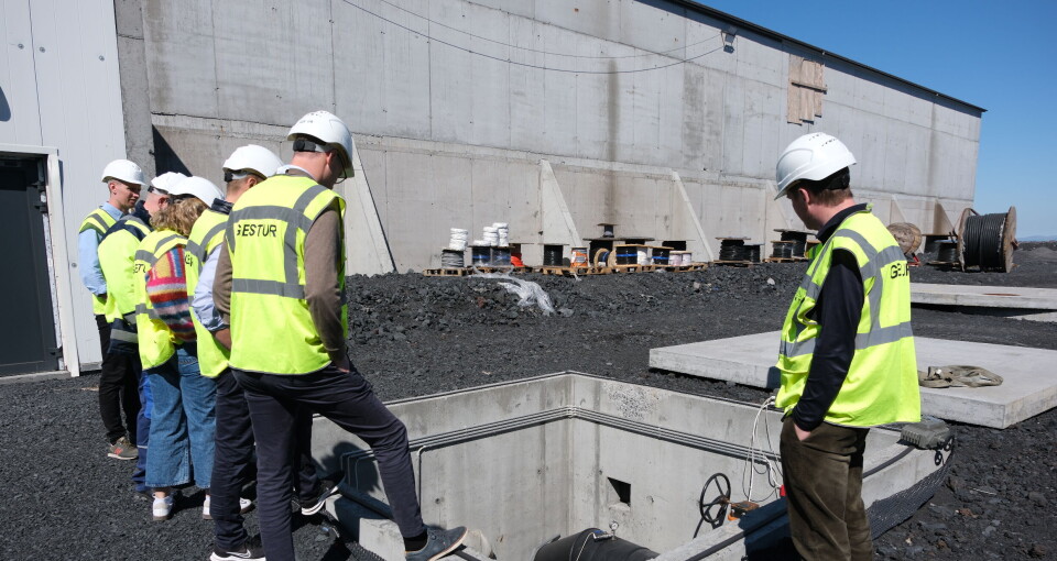 Operations director Hallgrimur Steinsson and representatives from AKVA group in front of the land-based facility on Vestmannaeyjar, where development is now well under way with phase two.